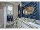 Double vanity bathroom with granite countertop and blue walls at 788 Awendaw Lakes Blvd, Awendaw, SC 29429