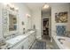 Elegant bathroom with double vanity and a large soaking tub at 788 Awendaw Lakes Blvd, Awendaw, SC 29429