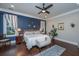 Main bedroom with king bed, hardwood floors, and blue accent wall at 788 Awendaw Lakes Blvd, Awendaw, SC 29429