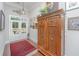 Elegant entryway with ornate wooden cabinet and red rug at 788 Awendaw Lakes Blvd, Awendaw, SC 29429