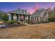 Brick and gray two-story home with landscaped yard and porch at 788 Awendaw Lakes Blvd, Awendaw, SC 29429