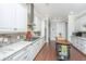 Bright kitchen featuring white cabinets, granite countertops, and an island at 788 Awendaw Lakes Blvd, Awendaw, SC 29429