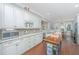 Eat-in kitchen with granite countertops, white cabinets and breakfast bar at 788 Awendaw Lakes Blvd, Awendaw, SC 29429
