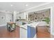 Modern kitchen with granite countertops, white cabinets, and stainless steel appliances at 788 Awendaw Lakes Blvd, Awendaw, SC 29429