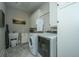 Laundry room with washer, dryer, utility sink, and ample cabinet space at 788 Awendaw Lakes Blvd, Awendaw, SC 29429