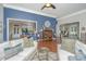Open living room with hardwood floors and a view into the kitchen at 788 Awendaw Lakes Blvd, Awendaw, SC 29429
