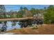 Scenic pond view reflecting homes and lush greenery at 788 Awendaw Lakes Blvd, Awendaw, SC 29429