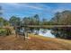 Serene pond view with bench and tranquil reflection at 788 Awendaw Lakes Blvd, Awendaw, SC 29429