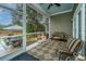 Screened porch with comfortable seating, overlooking the backyard at 788 Awendaw Lakes Blvd, Awendaw, SC 29429