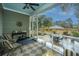 Relaxing screened porch with seating and view of the backyard at 788 Awendaw Lakes Blvd, Awendaw, SC 29429