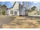 House's backyard with a grassy lawn and mature trees at 7897 Sabalridge Dr, North Charleston, SC 29418