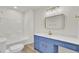 Updated bathroom with blue vanity, gold fixtures, and vinyl flooring at 7897 Sabalridge Dr, North Charleston, SC 29418