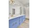 Bathroom with double vanity, blue cabinets, and gold accents at 7897 Sabalridge Dr, North Charleston, SC 29418