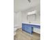 Updated bathroom with blue vanity, gold fixtures, and vinyl flooring at 7897 Sabalridge Dr, North Charleston, SC 29418