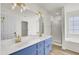 Bathroom with double vanity, blue cabinets, and gold accents at 7897 Sabalridge Dr, North Charleston, SC 29418