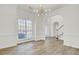 Dining room with hardwood floors, chandelier, and window at 7897 Sabalridge Dr, North Charleston, SC 29418