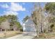 Side view of the house showcasing a three-car garage and driveway at 7897 Sabalridge Dr, North Charleston, SC 29418