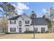 Two story white house with black shutters, a large front yard, and a lamp post at 7897 Sabalridge Dr, North Charleston, SC 29418