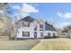 Two-story home with a white exterior, brick accents, and a landscaped yard at 7897 Sabalridge Dr, North Charleston, SC 29418