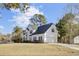 Two-story house with white siding, a dark roof, and a three-car garage at 7897 Sabalridge Dr, North Charleston, SC 29418