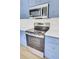 Stainless steel range and microwave in a kitchen with blue cabinets at 7897 Sabalridge Dr, North Charleston, SC 29418