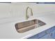 Modern kitchen sink and gold faucet with white countertops at 7897 Sabalridge Dr, North Charleston, SC 29418