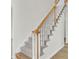 Elegant staircase with carpeted steps and wooden handrail at 7897 Sabalridge Dr, North Charleston, SC 29418