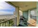 Private balcony with ocean and beach views, seating for two at 8000 Palmetto Dr # 505, Isle of Palms, SC 29451