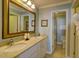 Bathroom with double sinks, granite countertop and large mirror at 8000 Palmetto Dr # 505, Isle of Palms, SC 29451