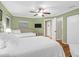 Relaxing bedroom featuring a large bed, ceiling fan, and wood floors for a cozy ambiance at 8000 Palmetto Dr # 505, Isle of Palms, SC 29451
