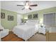 Charming bedroom with a queen bed, wood floors, and light green walls, creating a serene space at 8000 Palmetto Dr # 505, Isle of Palms, SC 29451
