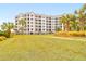 Exterior view of beachfront condo building, showing lush landscaping and architecture at 8000 Palmetto Dr # 505, Isle of Palms, SC 29451
