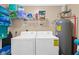 Functional laundry room with washer, dryer, water heater, and storage shelf at 8000 Palmetto Dr # 505, Isle of Palms, SC 29451