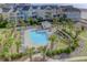 Community pool with surrounding lounge chairs and landscaping at 8000 Palmetto Dr # 505, Isle of Palms, SC 29451