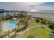 Community pool with surrounding lounge chairs and lush landscaping at 8000 Palmetto Dr # 505, Isle of Palms, SC 29451