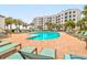 Beautiful pool with lounge chairs and beachfront condo in the background at 8000 Palmetto Dr # 505, Isle of Palms, SC 29451