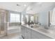 Bright bathroom featuring double sinks, a large mirror, soaking tub and a separate shower for a spa-like experience at 108 Maritime Way, Summerville, SC 29485