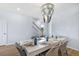 Well-lit dining room showcasing stylish light fixture, table setting, and interior stairs at 108 Maritime Way, Summerville, SC 29485