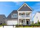 Two-story home with front-facing garage, double porch and neatly manicured front yard at 108 Maritime Way, Summerville, SC 29485