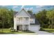 Charming two-story home featuring double porch, neutral siding, and a well-manicured lawn at 108 Maritime Way, Summerville, SC 29485