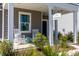 Covered front porch with rocking chairs and view of front garden at 108 Maritime Way, Summerville, SC 29485