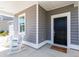 View of covered front porch with rocking chairs, house siding and front door at 108 Maritime Way, Summerville, SC 29485