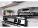 Close-up of modern range and white subway tile backsplash in well-designed kitchen at 108 Maritime Way, Summerville, SC 29485