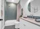 Stylish bathroom with blue tiled shower, updated fixtures and a modern sink at 120 Charleston Blvd, Isle of Palms, SC 29451