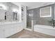 Modern bathroom featuring a double vanity, glass shower, and soaking tub at 120 Charleston Blvd, Isle of Palms, SC 29451