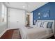 Charming bedroom featuring a striking blue accent wall and ample natural light at 120 Charleston Blvd, Isle of Palms, SC 29451