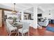Spacious dining room with a modern glass table and views of the kitchen and living area at 120 Charleston Blvd, Isle of Palms, SC 29451