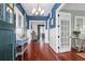 Inviting foyer with hardwood floors, blue accent walls, and decorative lighting at 120 Charleston Blvd, Isle of Palms, SC 29451