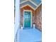 Charming front door with blue porch ceiling, cedar shake siding, and lantern sconces at 120 Charleston Blvd, Isle of Palms, SC 29451