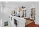 Bright living room boasts stylish decor, wood floors, built-in bookcases, and modern ceiling fan at 120 Charleston Blvd, Isle of Palms, SC 29451
